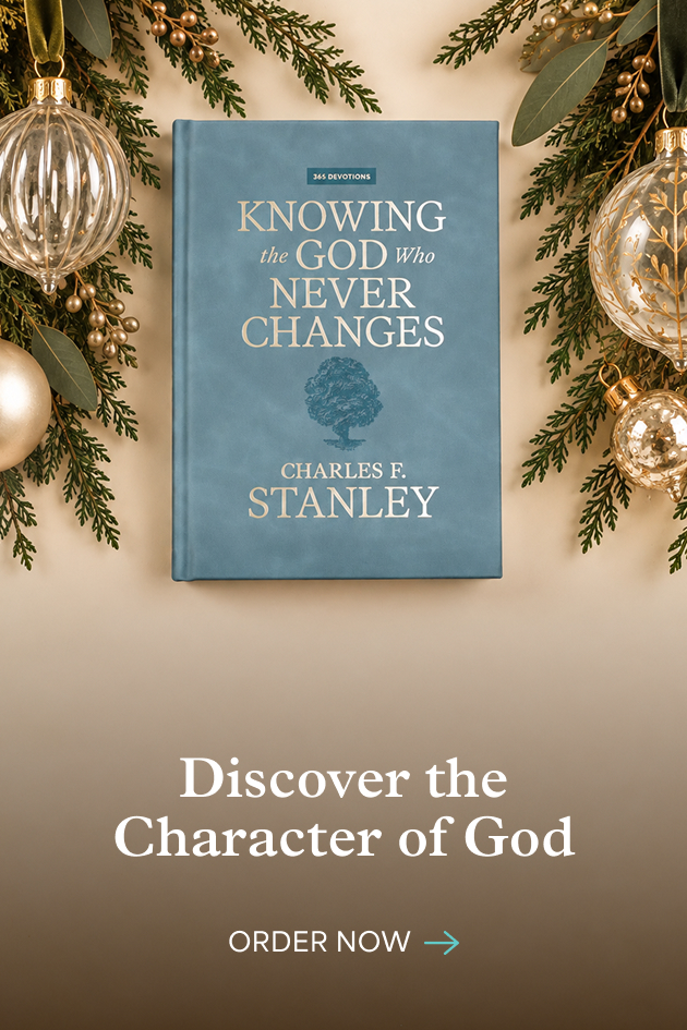 Knowing the God Who Never Changes by Charles F. Stanley, framed by Christmas greenery and ornaments. Discover the character of God. Order now.